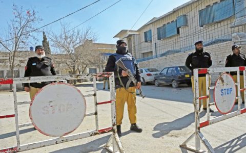 policemen stand guard outside the provincial election commission office ahead of the upcoming general elections in quetta photo afp